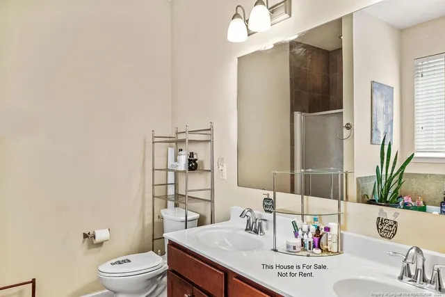 a bathroom with a sink a toilet and shower curtain