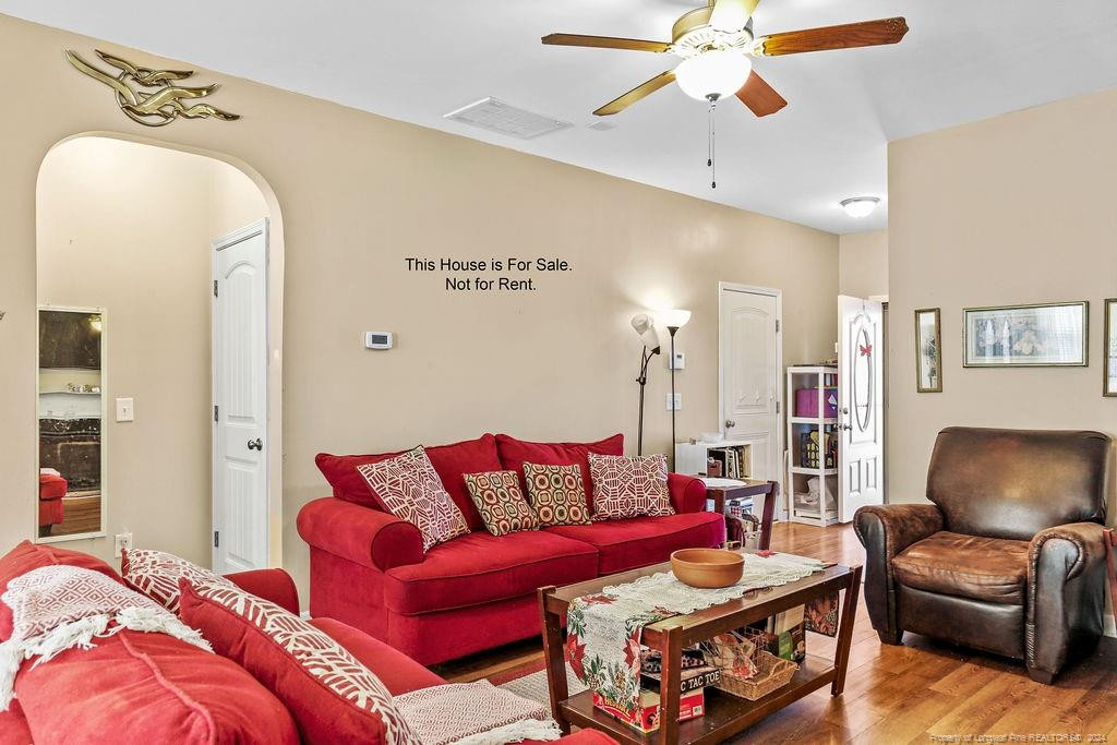 113 Meherrin Loop Raeford, NC 28376 - Photo 24 of 27 a living room with furniture a rug and a chandelier