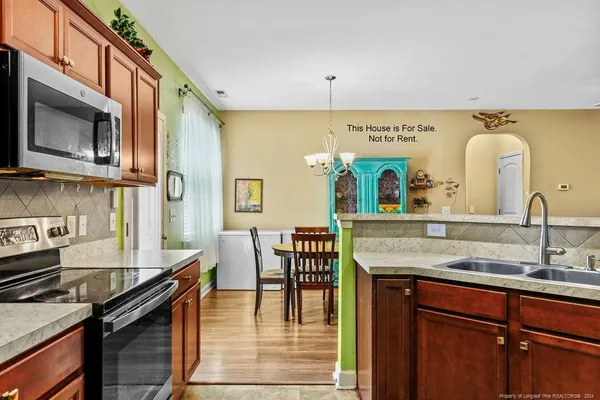 a kitchen with a sink a stove and cabinets