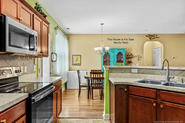 a kitchen with a sink a stove and cabinets