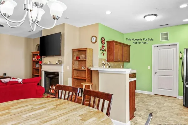 a bedroom with a bed dresser and a flat tv screen