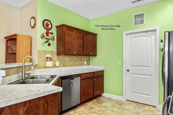 a kitchen with a sink and a refrigerator