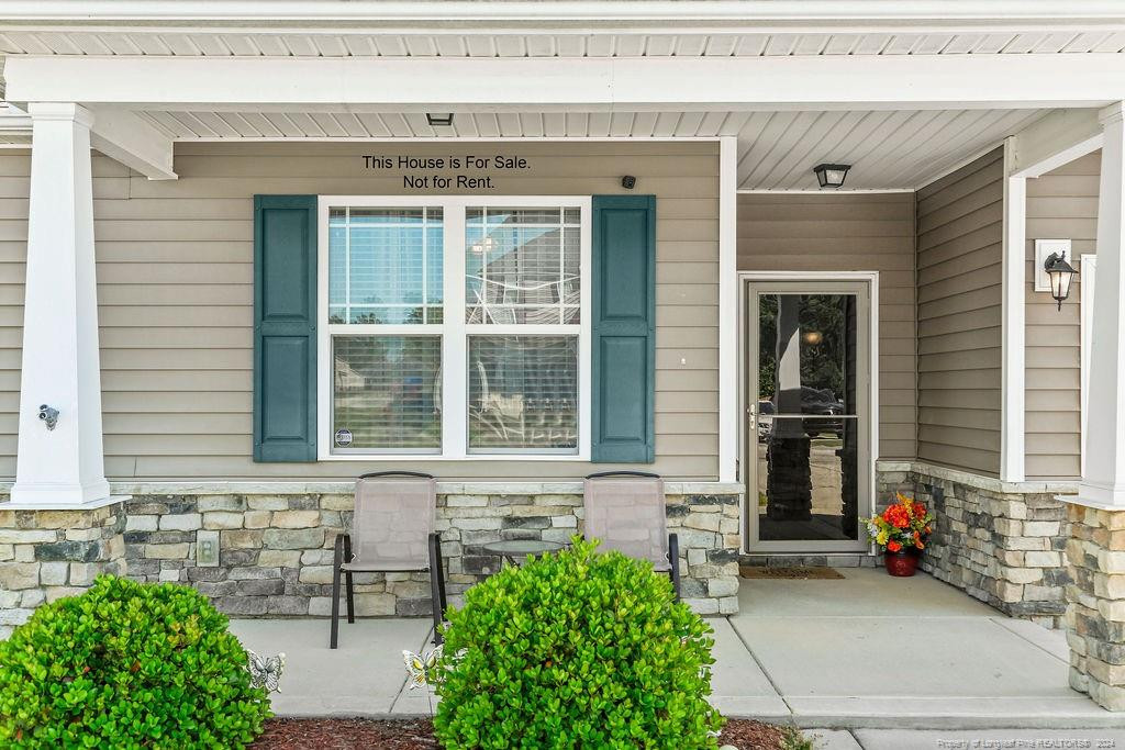 113 Meherrin Loop Raeford, NC 28376 - Photo 3 of 27 a front view of a house with outdoor seating