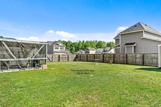 a view of a house with a yard and sitting area