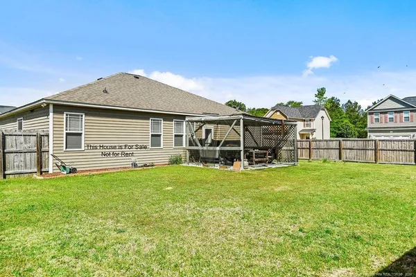 a view of a house with a backyard