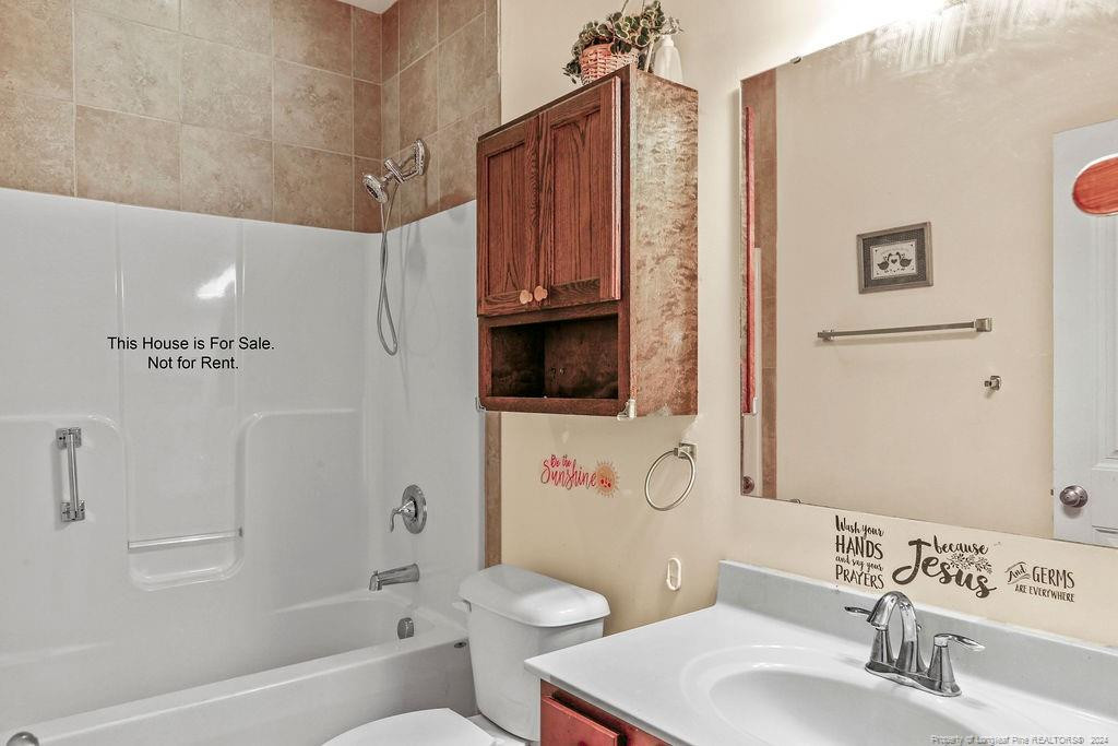 113 Meherrin Loop Raeford, NC 28376 - Photo 9 of 27 a bathroom with a sink a toilet and shower