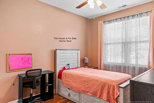 a bed sitting in a bedroom next to a window