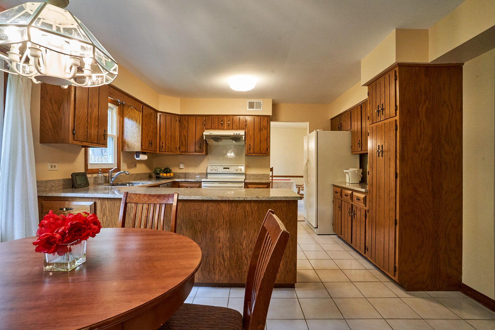 2844 Sun Valley Road Lisle, IL 60532 - Photo 8 of 32 a kitchen with stainless steel appliances granite countertop a refrigerator a stove a sink a dining table and chairs with wooden floor