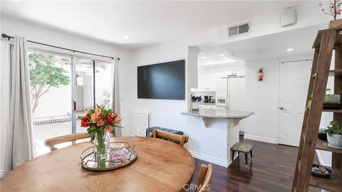 a view of a dining room with furniture wooden floor and a chandelier
