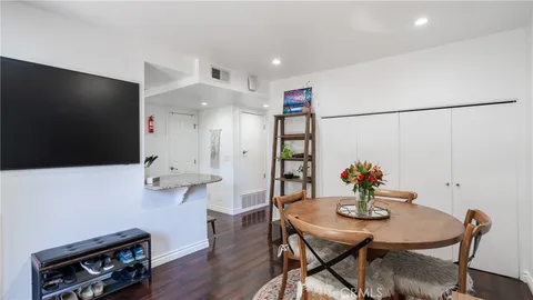 a view of a room with furniture and wooden floor