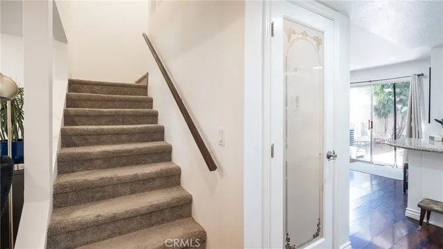 a view of staircase with white walls and windows