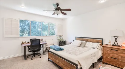 a bedroom with a bed and a desk