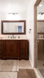 a bathroom with a sink a mirror and shower