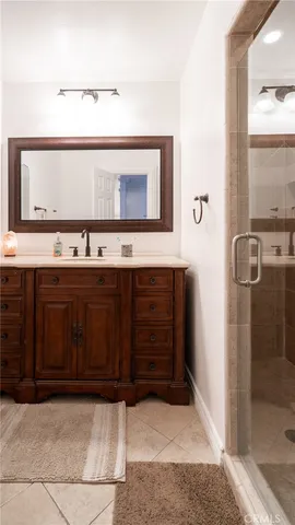 a bathroom with a sink a mirror and shower
