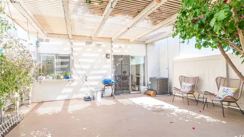 a building outdoor space with patio furniture and potted plants