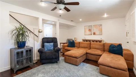a living room with furniture ceiling fan and a rug