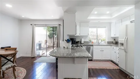 a kitchen with sink refrigerator and window