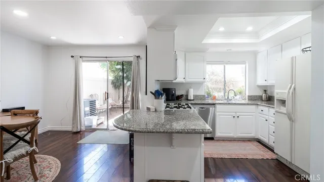 a kitchen with sink refrigerator and window