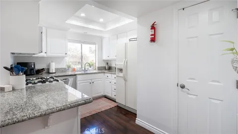a kitchen with a sink refrigerator and cabinets