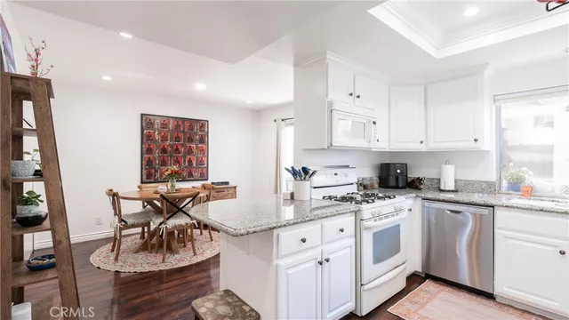 a kitchen a sink refrigerator and cabinets