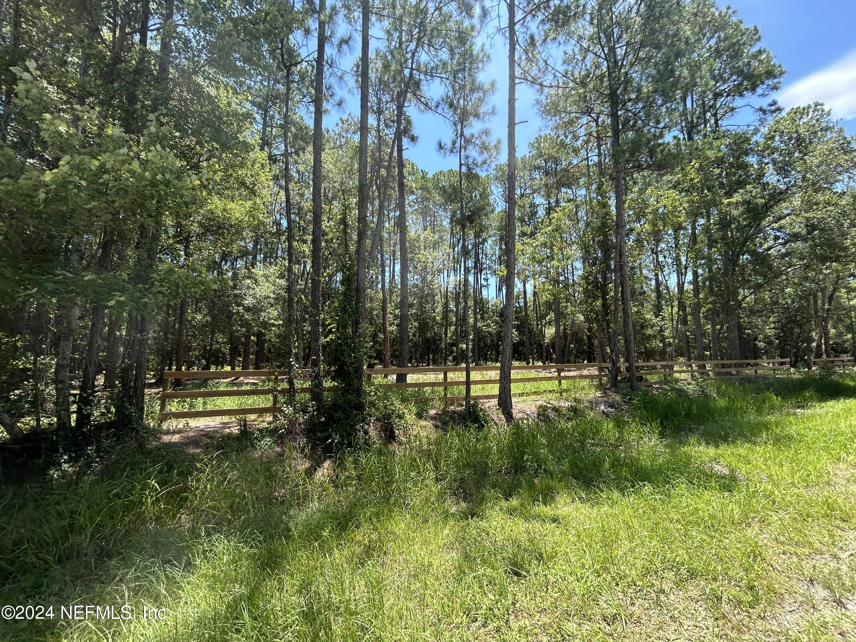 a swimming pool with trees in the background