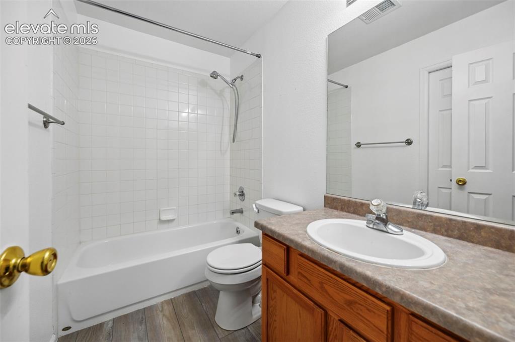 431 Kitfield View Colorado Springs, CO 80916 - Photo 20 of 27 a bathroom with a granite countertop sink a toilet and shower