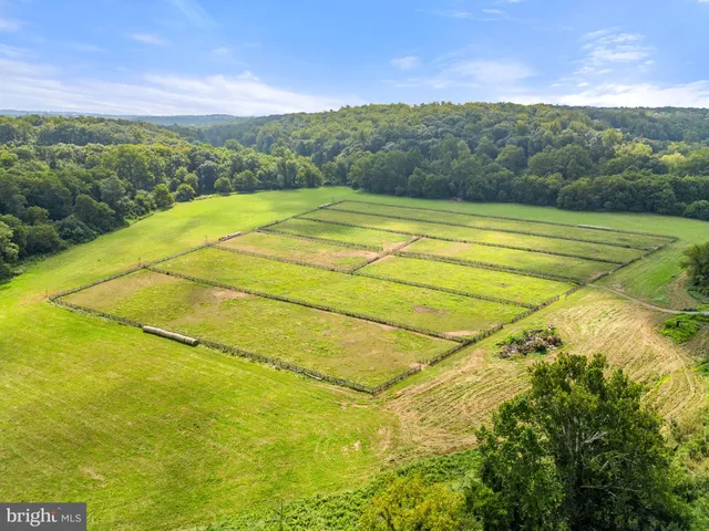 an aerial view of a house with a garden and swimming pool