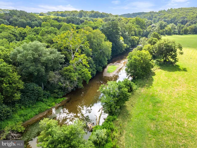 an aerial view of residential houses with outdoor space and swimming pool