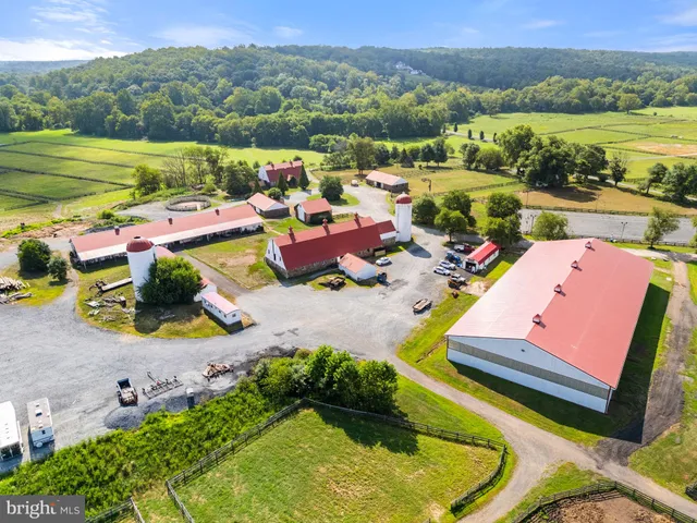 an aerial view of a house with a garden and lake view