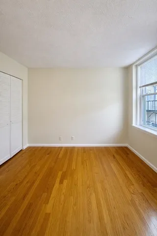 a view of an empty room and wooden floor