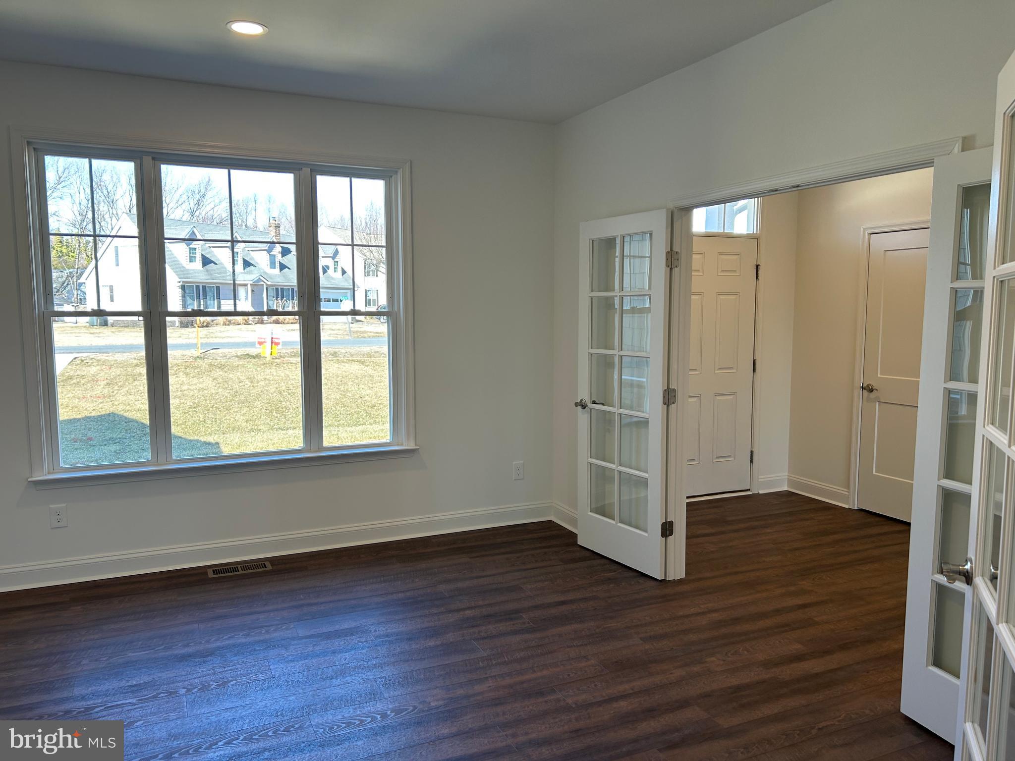 312 Queens Colony High Road Stevensville, MD 21666 - Photo 38 of 57 an empty room with wooden floor and windows