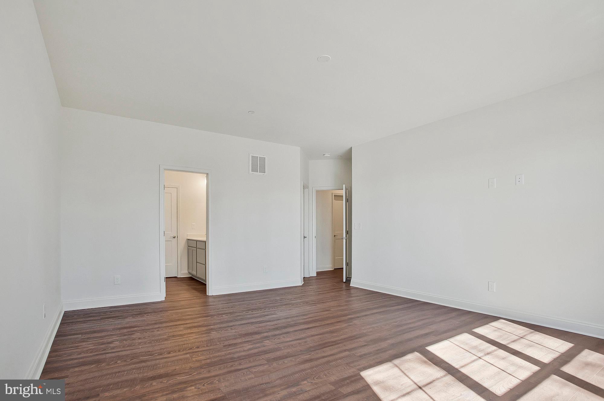 312 Queens Colony High Road Stevensville, MD 21666 - Photo 50 of 57 a view of an empty room and wooden floor