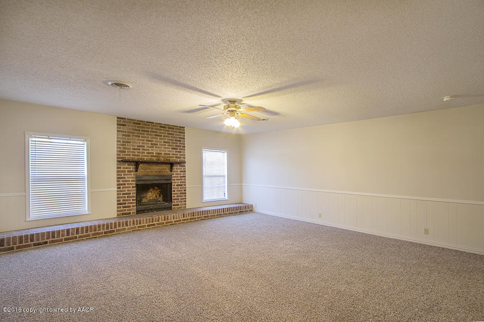 4314 Crockett Street Amarillo, TX 79110 - Photo 3 of 21 an empty room with fireplace and windows