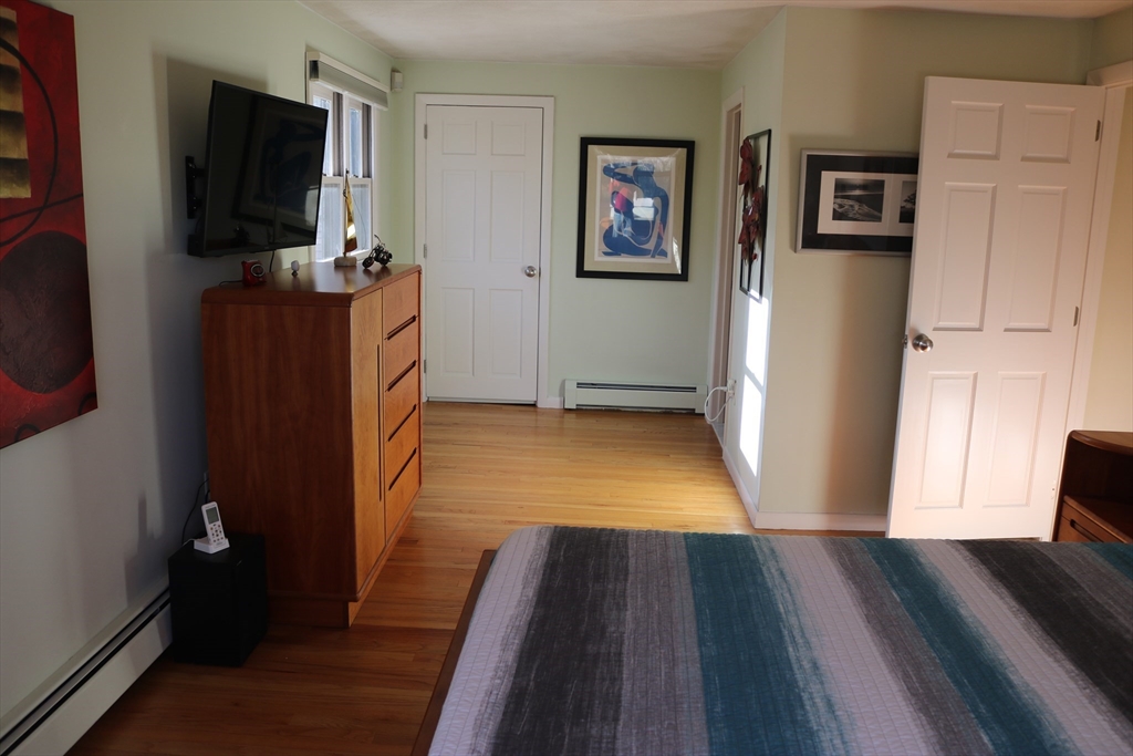 30 Southwick Road Sutton, MA 01590 - Photo 20 of 27 a view of a livingroom with wooden floor and a flat screen tv