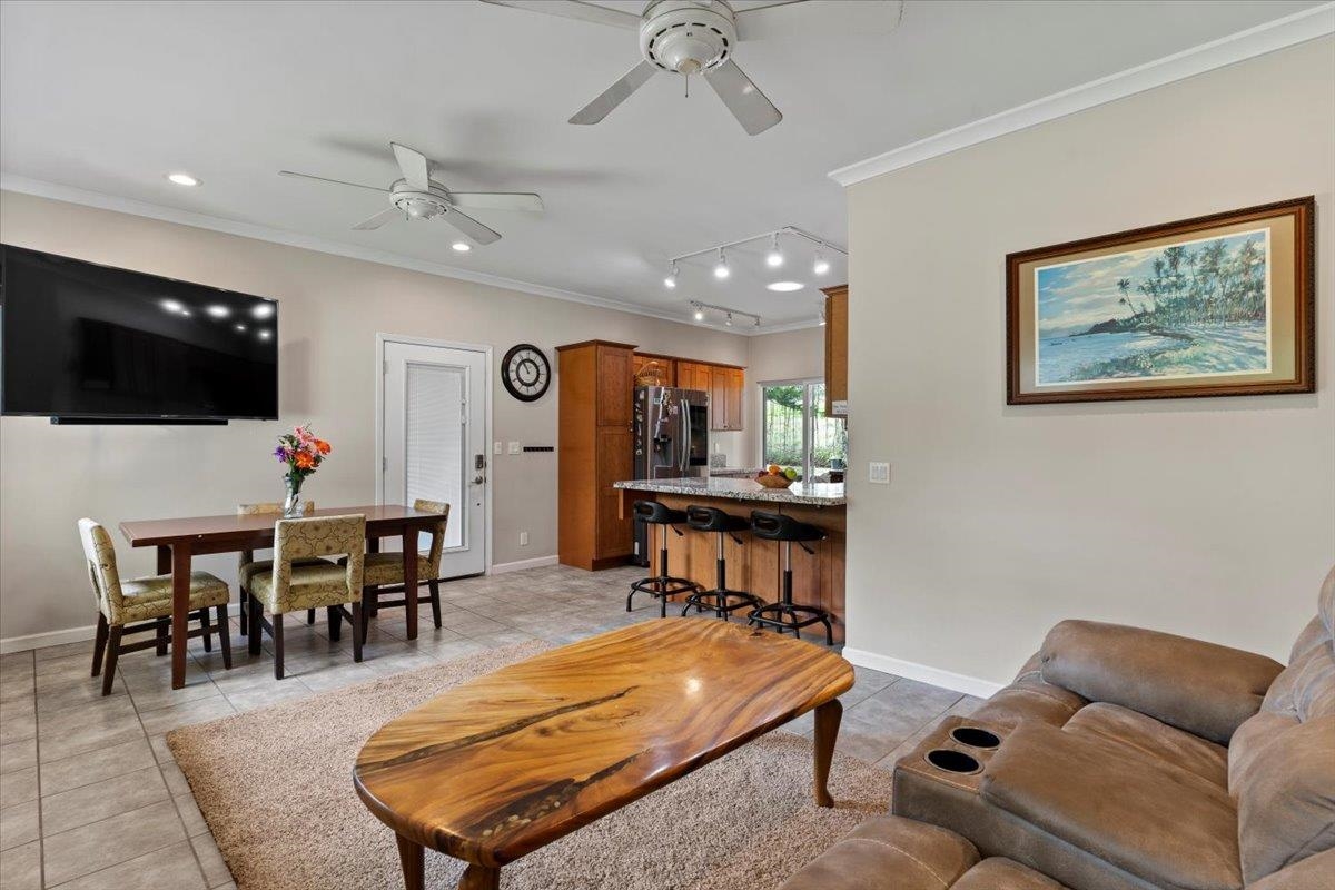 200 Awalau Road, Unit B Haiku, HI 96708 - Photo 11 of 39 a living room with furniture a flat screen tv and kitchen view