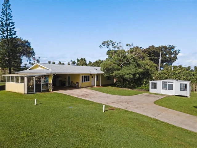 a front view of a house with a garden