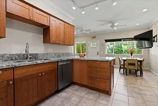 a kitchen with granite countertop sink window and chairs