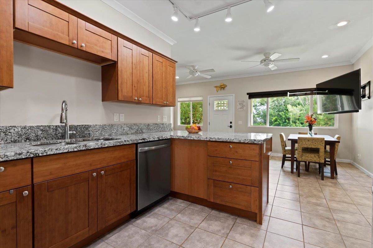 200 Awalau Road, Unit B Haiku, HI 96708 - Photo 21 of 39 a kitchen with granite countertop sink window and chairs