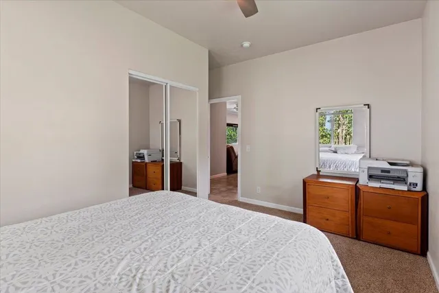 a bedroom with a bed and a desk