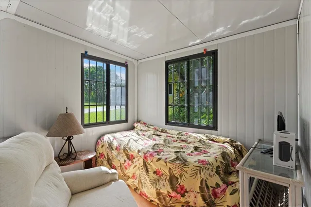 a bedroom with a bed next to a window