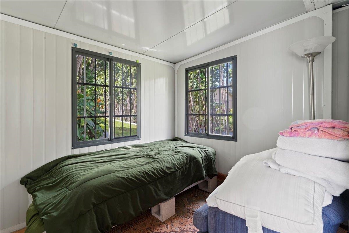 200 Awalau Road, Unit B Haiku, HI 96708 - Photo 35 of 39 a bedroom with a bed next to a window