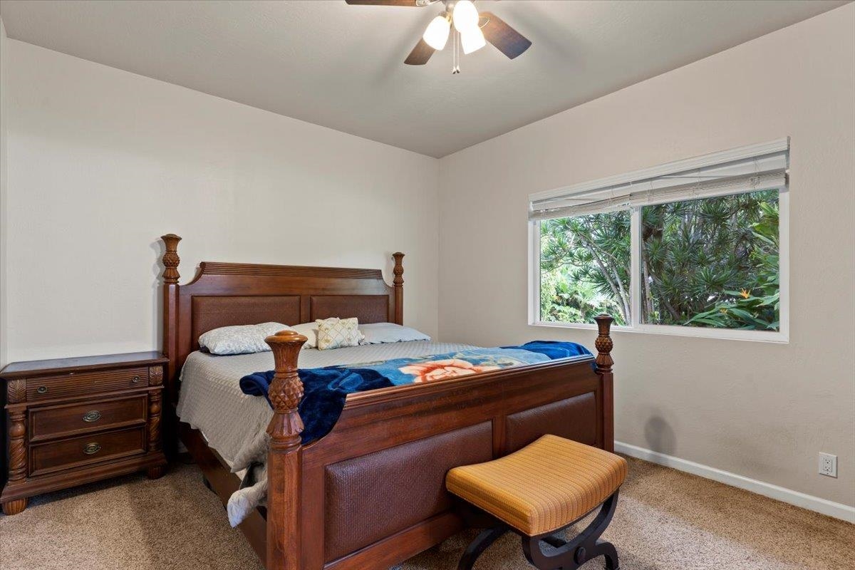 200 Awalau Road, Unit B Haiku, HI 96708 - Photo 7 of 39 a bed room with a bed and a chair