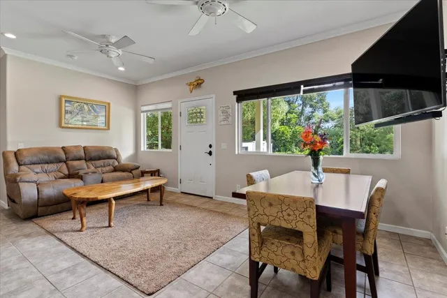 a living room with furniture a large window and a table