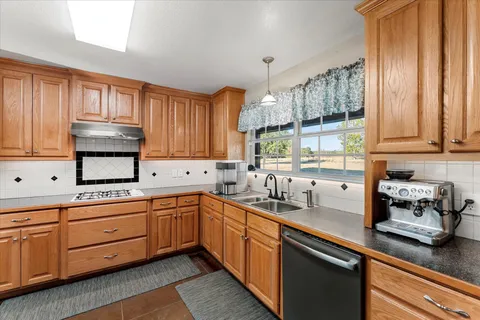 a kitchen with granite countertop stainless steel appliances and cabinets