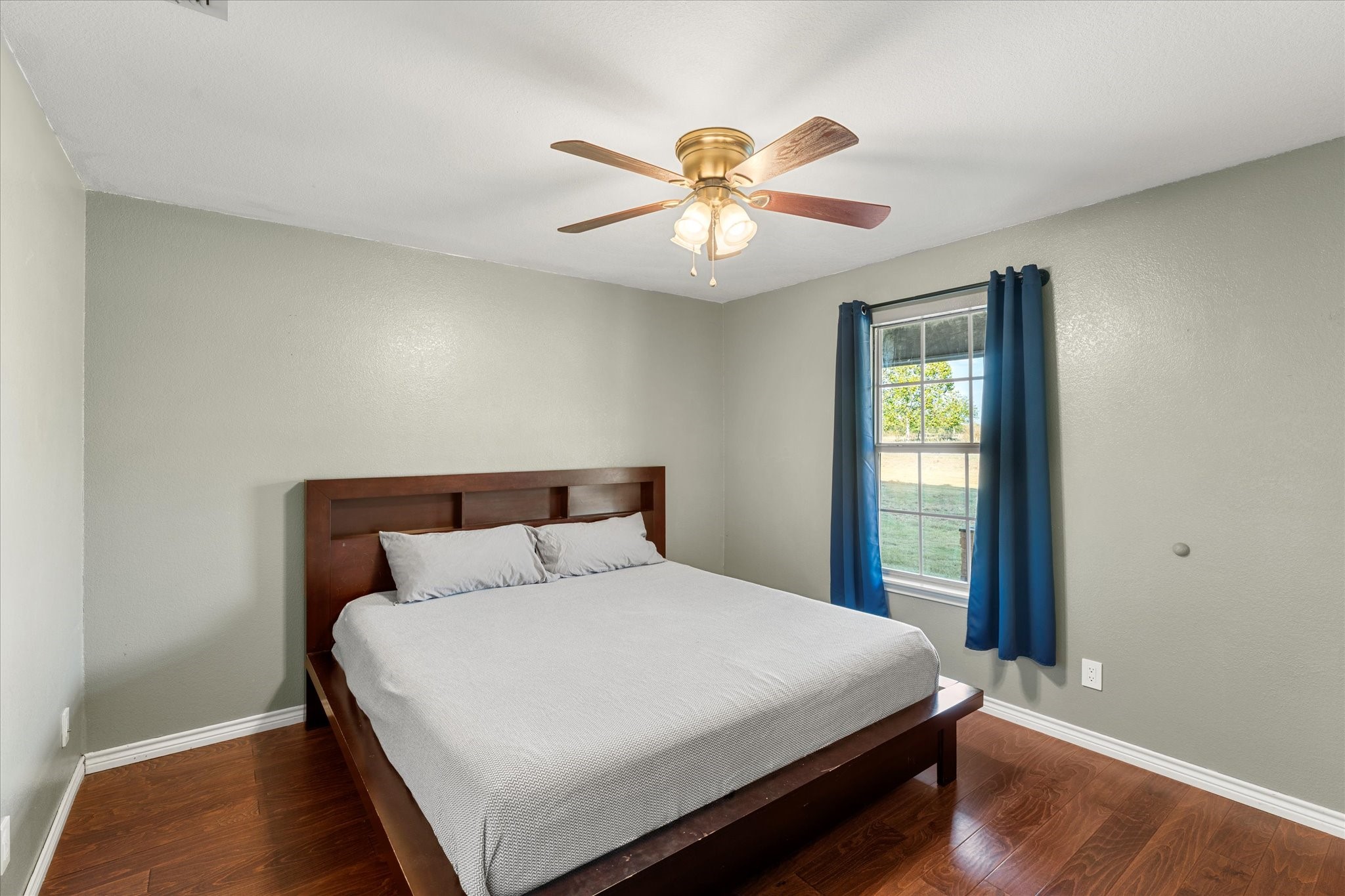 3115 Rains County Road 2610 Alba, TX 75410 - Photo 17 of 49 a bedroom with a large bed and a chandelier