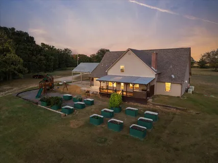 an aerial view of a house with a yard