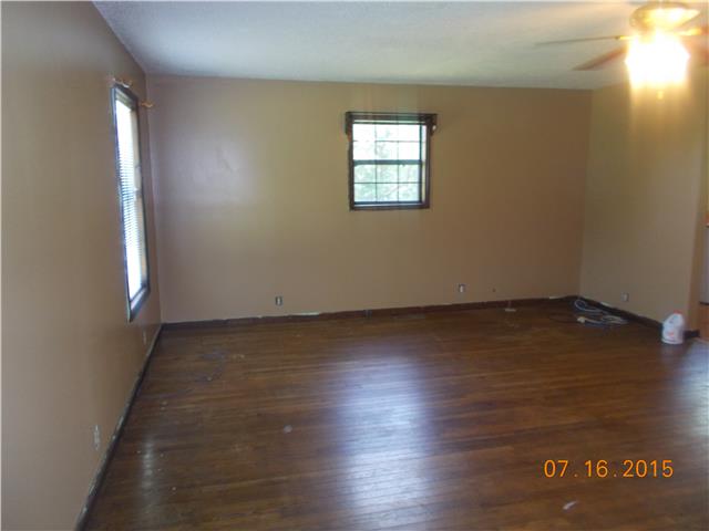 385 Chicken Creek Road Pulaski, TN 38478 - Photo 3 of 15 an empty room with wooden floor and windows