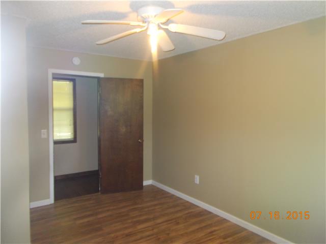 385 Chicken Creek Road Pulaski, TN 38478 - Photo 5 of 15 a view of an empty room with wooden floor and a window