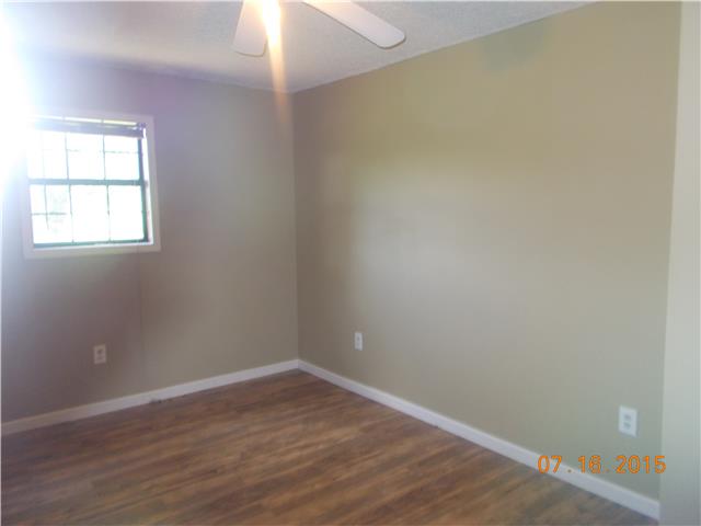 385 Chicken Creek Road Pulaski, TN 38478 - Photo 7 of 15 an empty room with wooden floor and windows