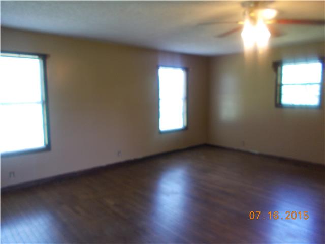 385 Chicken Creek Road Pulaski, TN 38478 - Photo 9 of 15 an empty room with wooden floor and windows